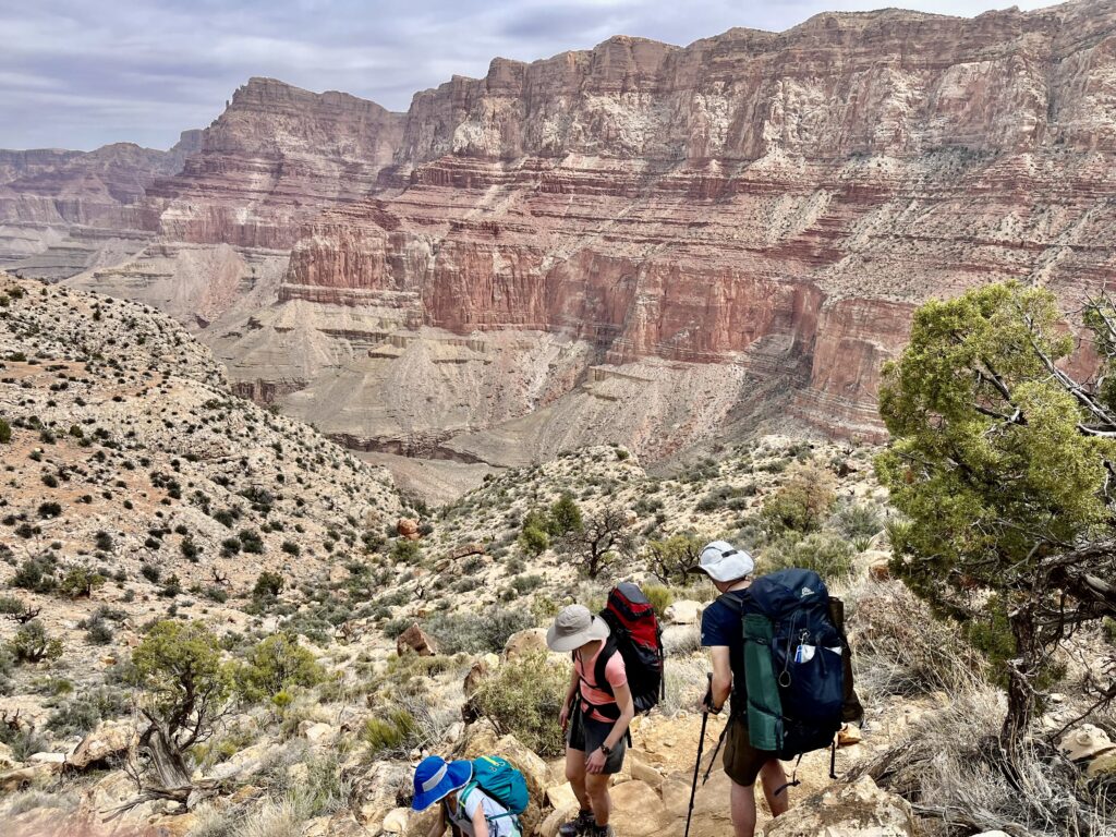 Descending by great canyon cliffs.