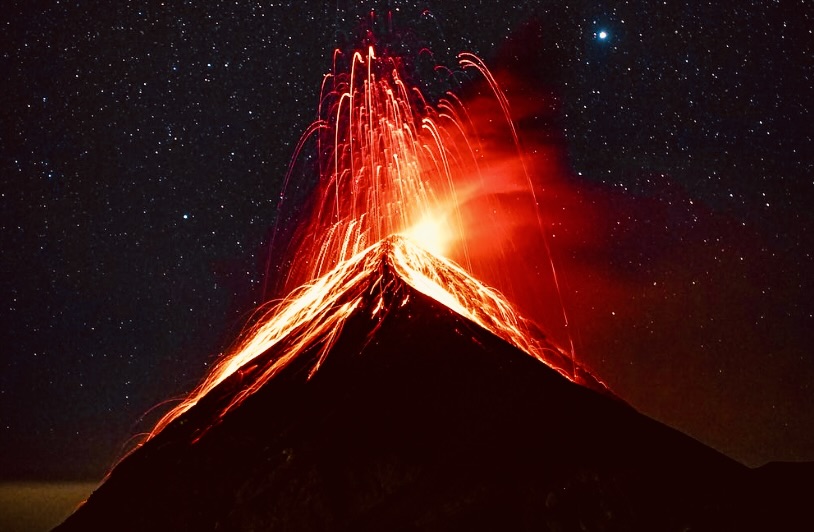 The massive Volcán Fuego erupts in the night.