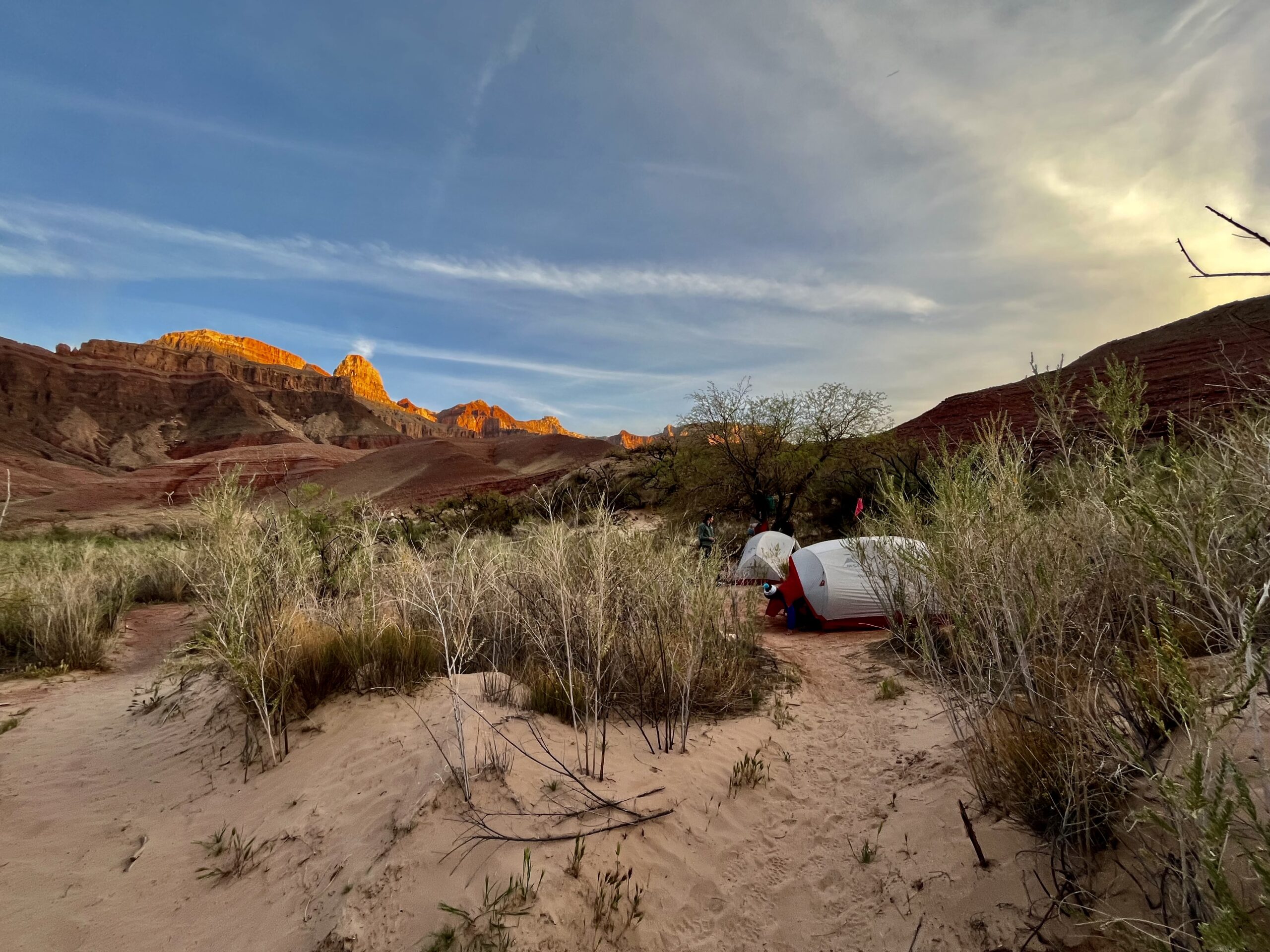 Tents with sunset above.