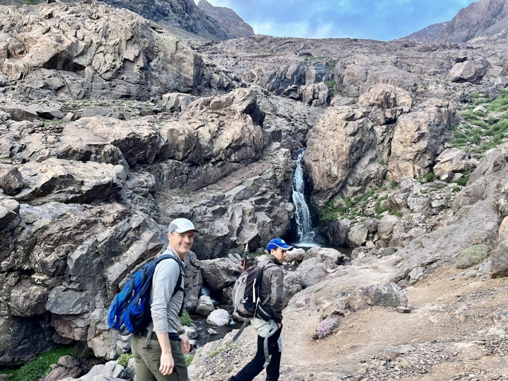 Hikers pass a waterfall on Mt. Toubkal.