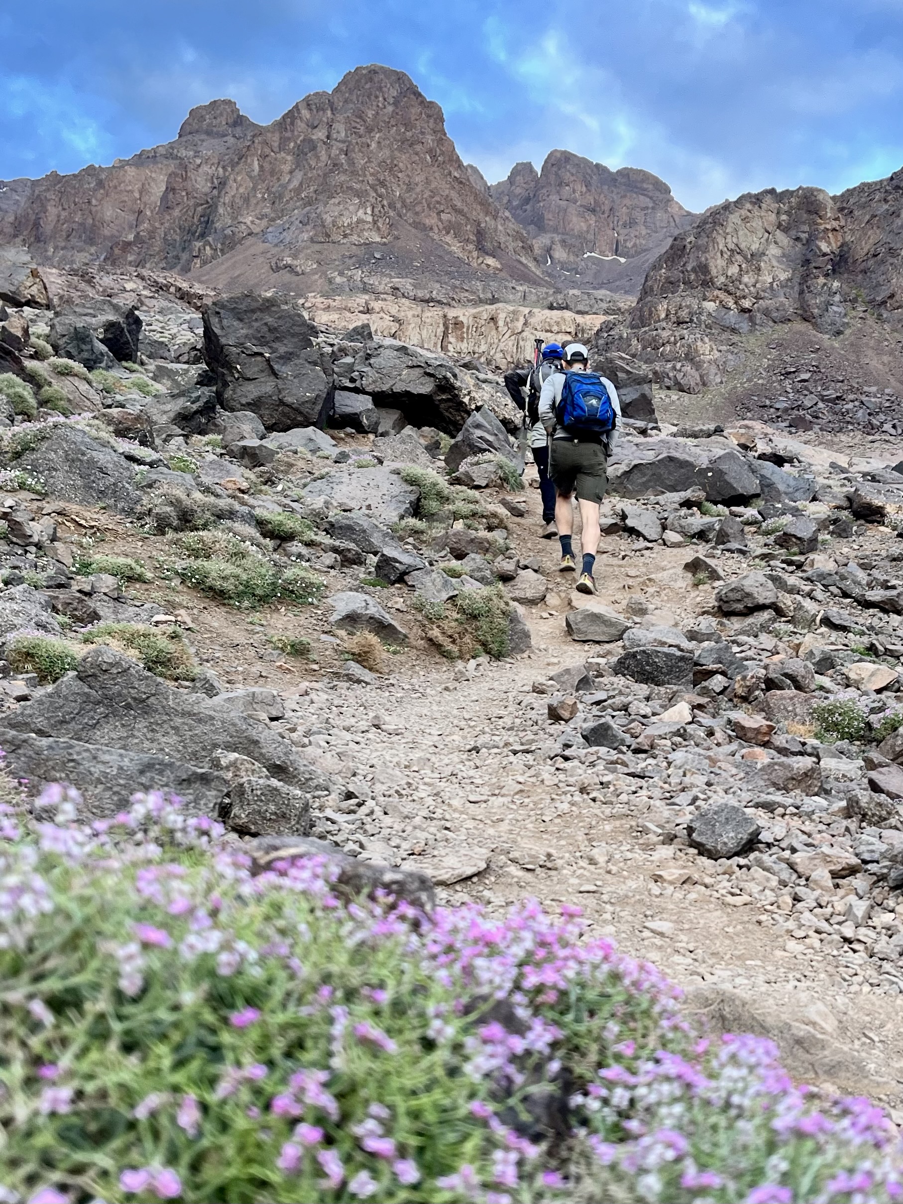 Hikers climb toward Toubkal pass.